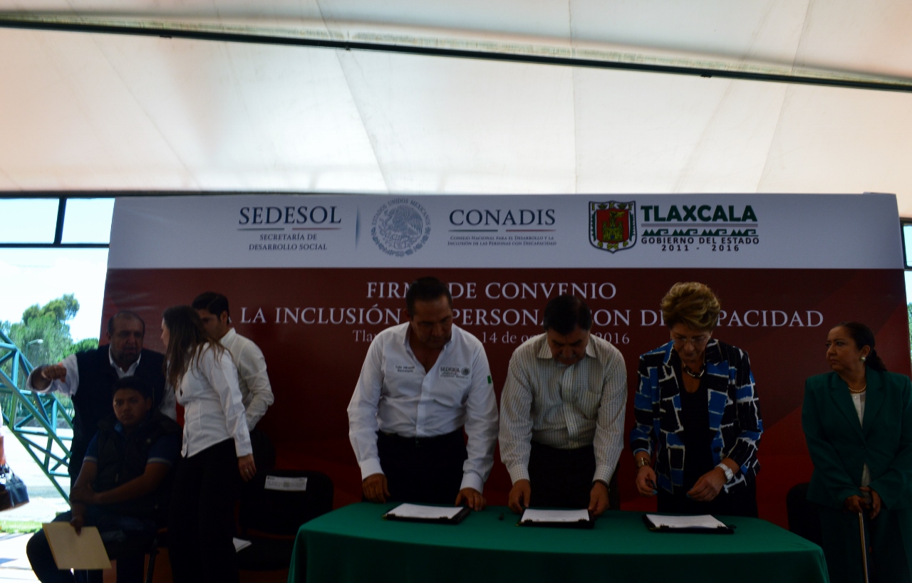 La Dra. Mercedes Juan López, Directora General del CONADIS y Mariano González Zarur, Gobernador del Estado de Tlaxcala, firman convenio en favor de las personas con discapacidad; el Secretario de la SEDESOL, Luis Enrique Miranda, firma como testigo.