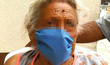 Doña María con cubrebocas en la entrada del hospital