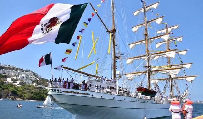 velero adornado con banderas pequeñas y la bandera de México mas grande